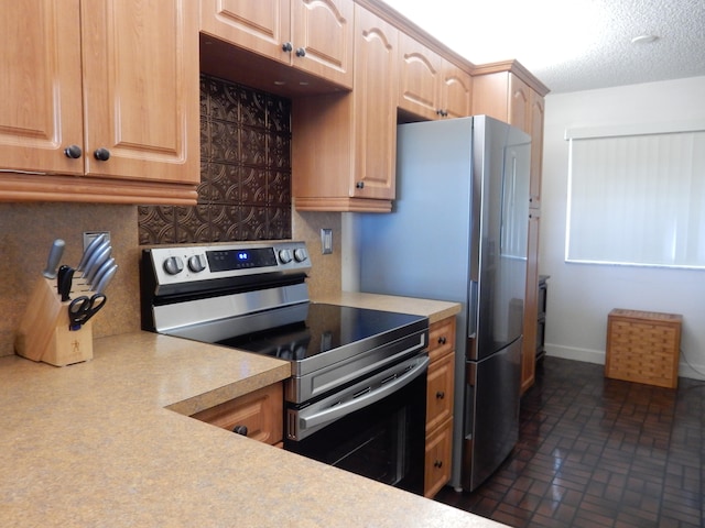 kitchen featuring stainless steel range with electric cooktop and a textured ceiling