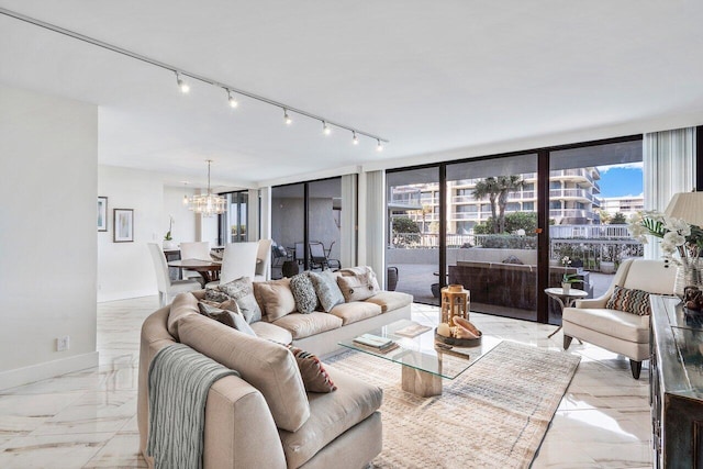 tiled living room with a wall of windows, track lighting, and a chandelier