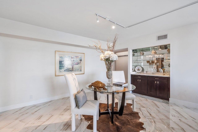 tiled dining space with track lighting