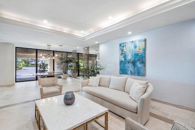 living room featuring a raised ceiling, a chandelier, and light tile flooring