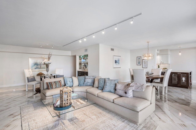 living room featuring a chandelier and track lighting