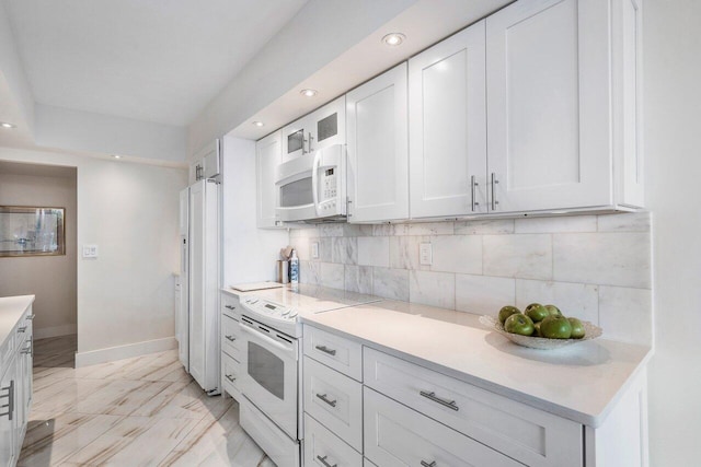 kitchen with white appliances, tasteful backsplash, white cabinetry, and light tile floors