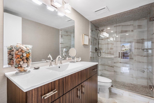 bathroom featuring toilet, a shower with door, tile flooring, and vanity