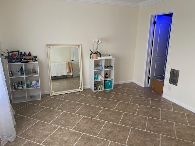 miscellaneous room with dark tile floors and crown molding