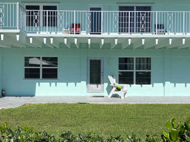 rear view of house featuring a lawn