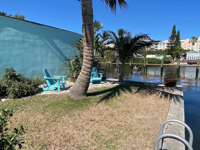 view of yard with a dock and a water view