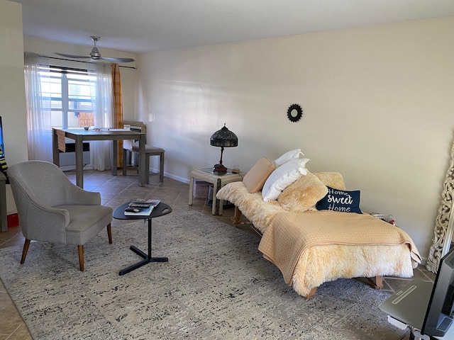 sitting room with light tile flooring and ceiling fan