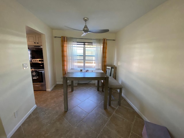 tiled dining space with ceiling fan