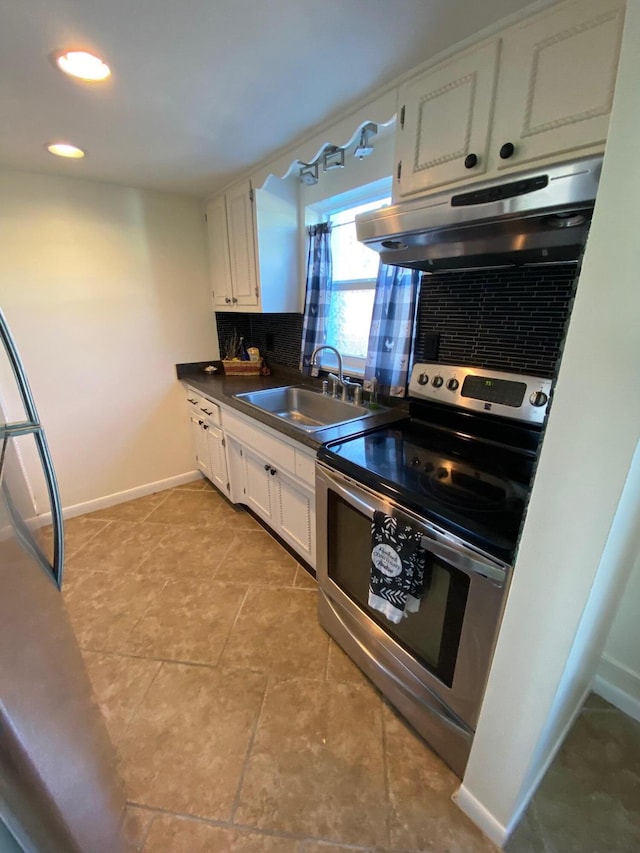 kitchen featuring tasteful backsplash, light tile floors, stainless steel electric range, sink, and white cabinetry