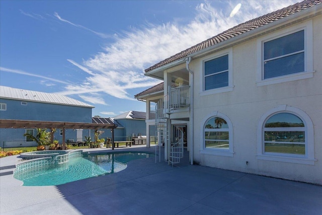 view of pool with a patio and an in ground hot tub