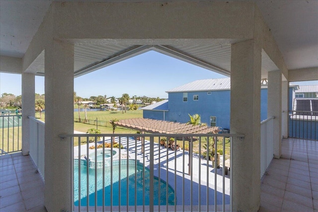 balcony featuring a pool with hot tub