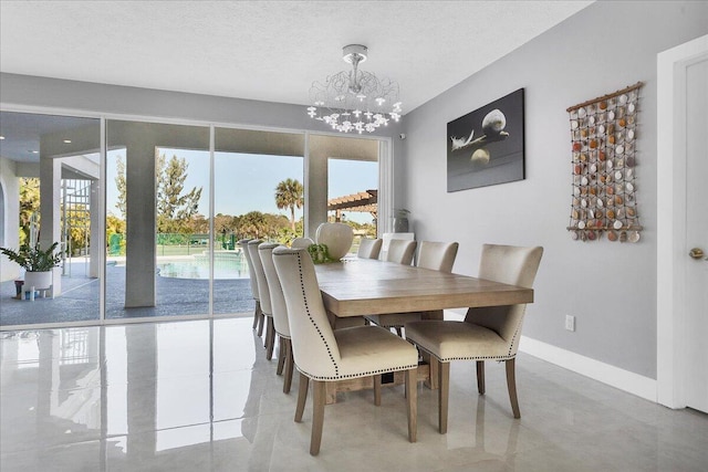 dining room with a notable chandelier and a textured ceiling