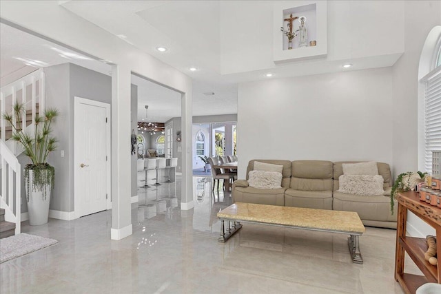 living room with a chandelier and light tile floors