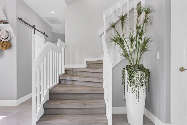 staircase featuring a barn door