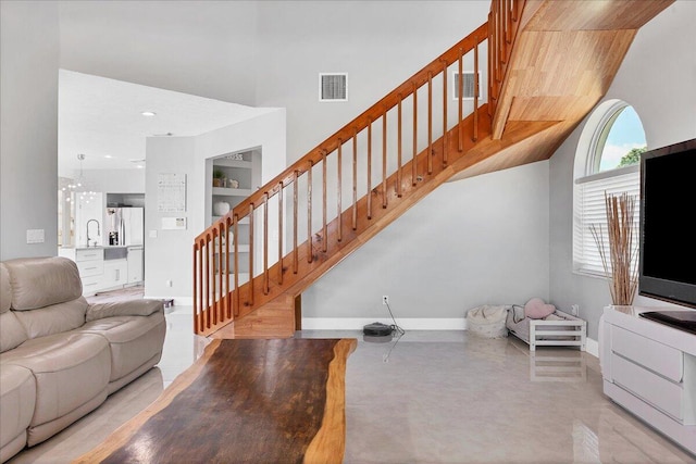 living room featuring sink and a chandelier