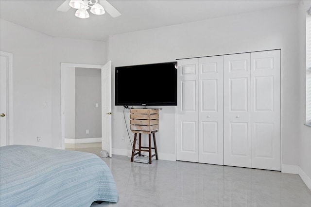 bedroom with a closet, light tile flooring, and ceiling fan