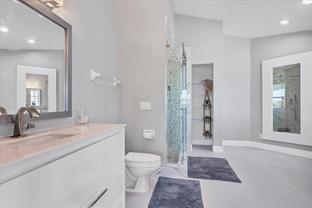 bathroom featuring vanity, walk in shower, tile flooring, and toilet