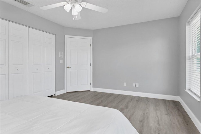 bedroom featuring a closet, ceiling fan, and dark hardwood / wood-style floors