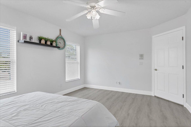 bedroom with ceiling fan and light wood-type flooring