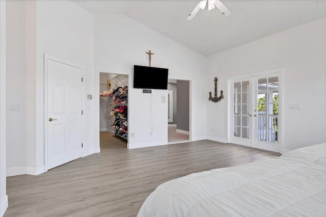 bedroom with ceiling fan, access to exterior, high vaulted ceiling, light hardwood / wood-style flooring, and french doors