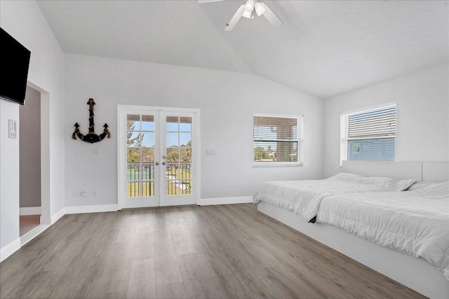 unfurnished bedroom with multiple windows, ceiling fan, access to exterior, light hardwood / wood-style floors, and french doors