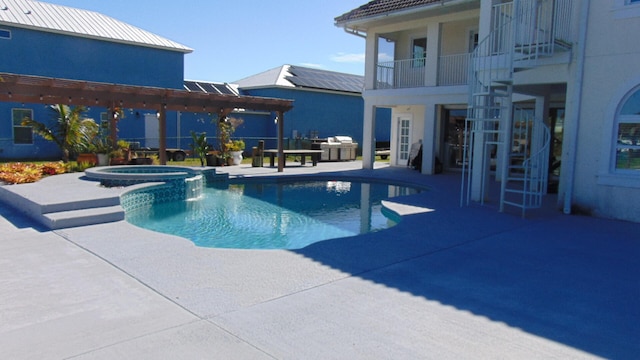 view of swimming pool with a pergola, a patio area, and an in ground hot tub