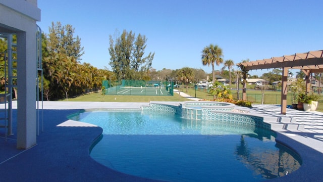 view of pool with an in ground hot tub