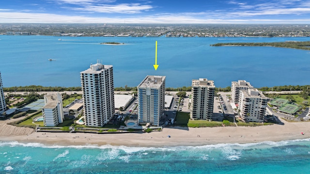 drone / aerial view featuring a view of the beach and a water view