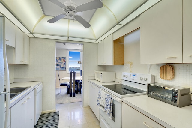 kitchen featuring light tile floors, ceiling fan, white appliances, and white cabinetry