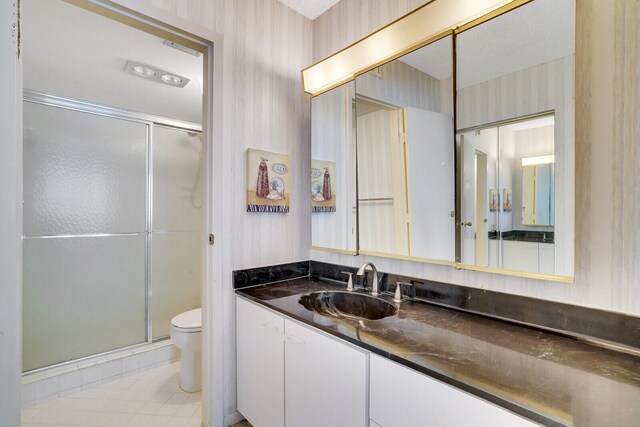 bathroom with toilet, tile flooring, an enclosed shower, and vanity