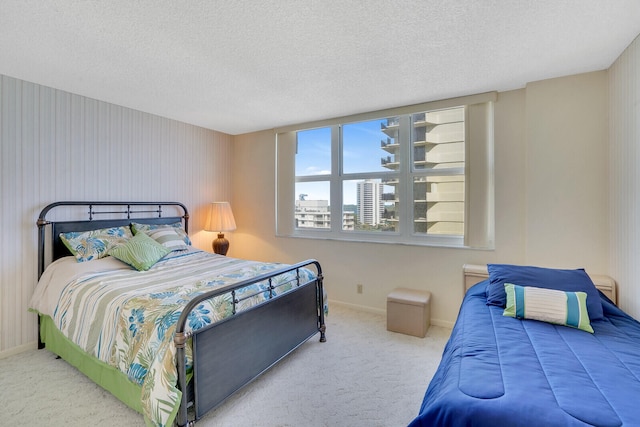 bedroom featuring light carpet and a textured ceiling