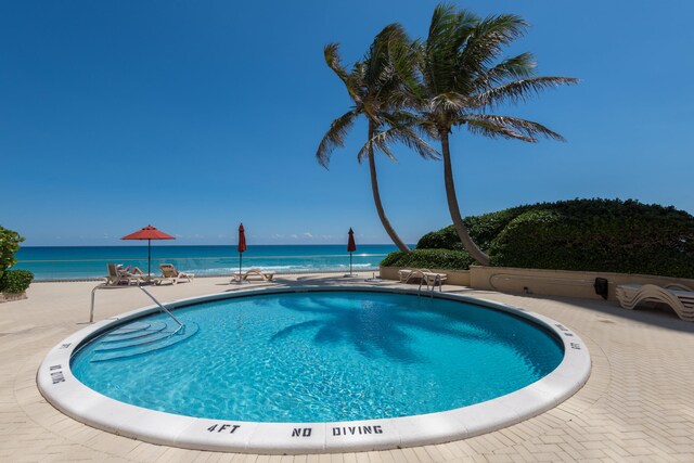 view of swimming pool with a water view