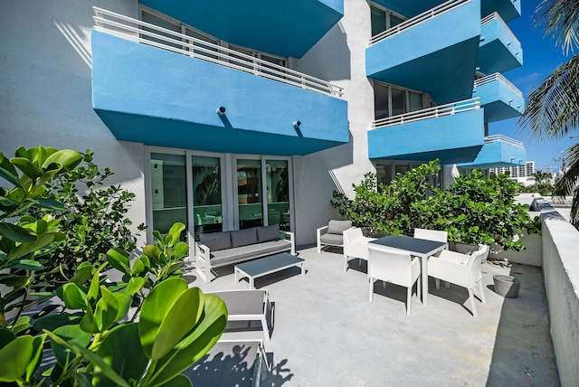 view of patio featuring outdoor lounge area and a balcony