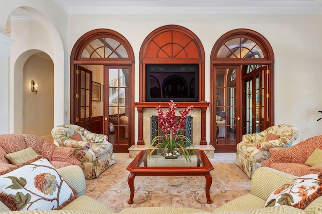 living room featuring a high end fireplace and ornamental molding