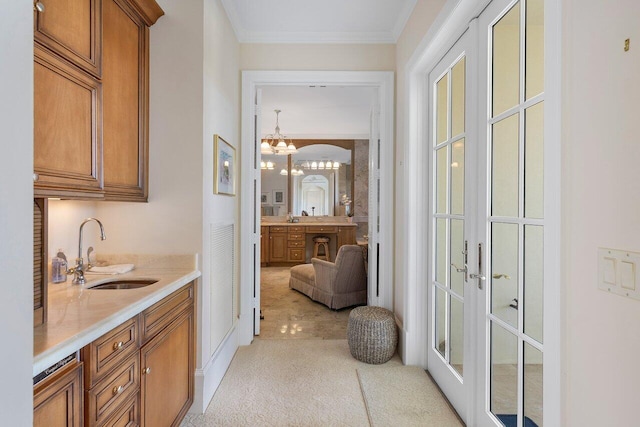 bathroom with vanity, a chandelier, french doors, and ornamental molding