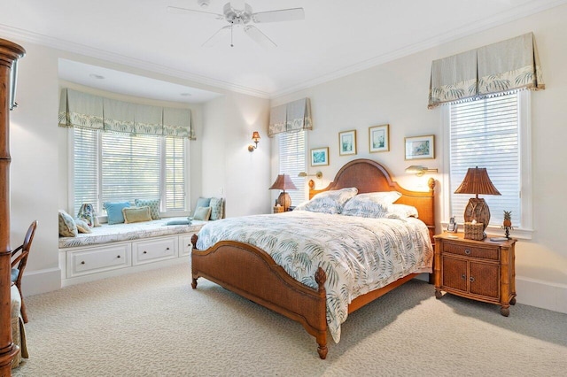 carpeted bedroom with ceiling fan, ornamental molding, and multiple windows