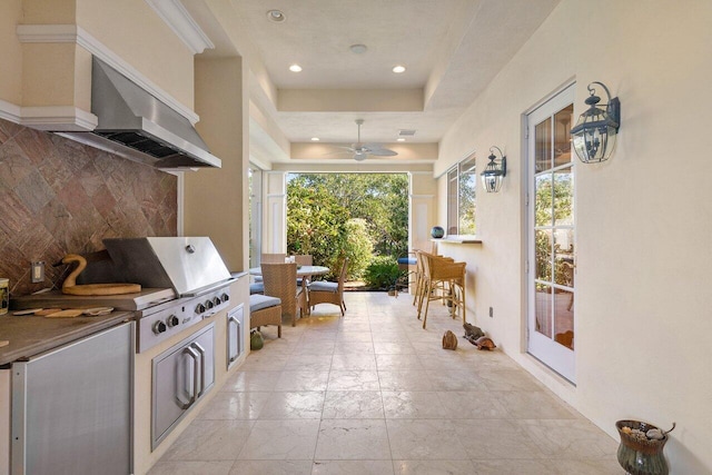 interior space with area for grilling, ceiling fan, and exterior kitchen