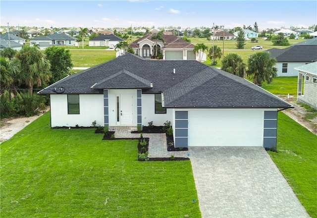 view of front facade featuring a front yard and a garage