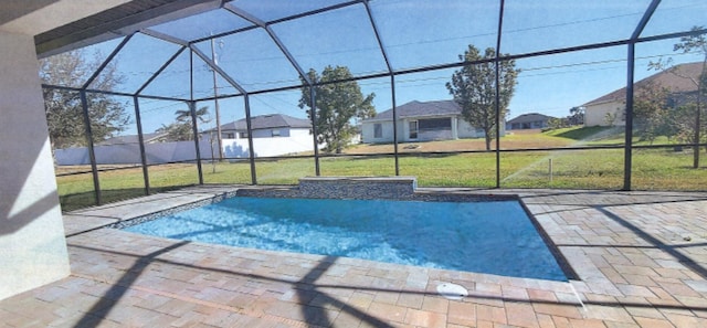 view of swimming pool with glass enclosure, a patio area, and a yard