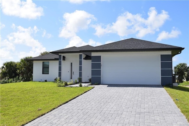 view of front of property featuring a garage and a front yard