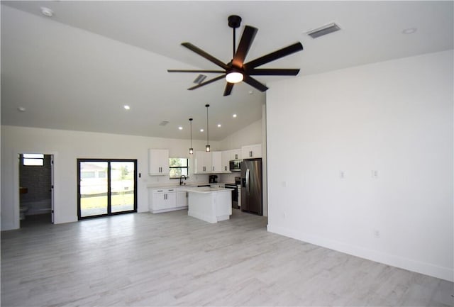 unfurnished living room featuring ceiling fan, high vaulted ceiling, sink, and light hardwood / wood-style floors