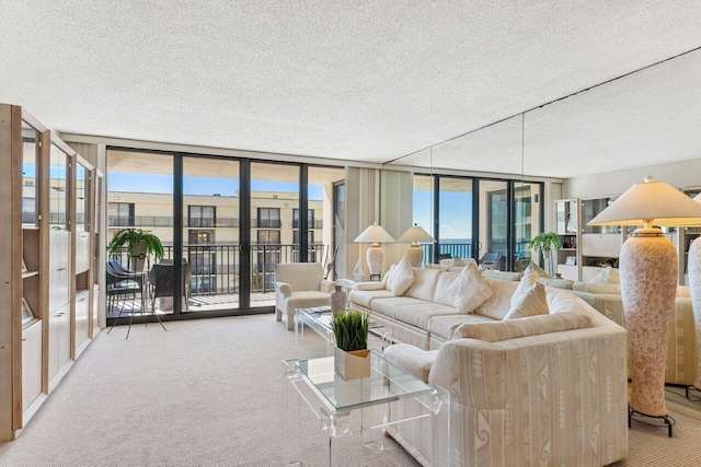 living room featuring floor to ceiling windows, light colored carpet, and a textured ceiling