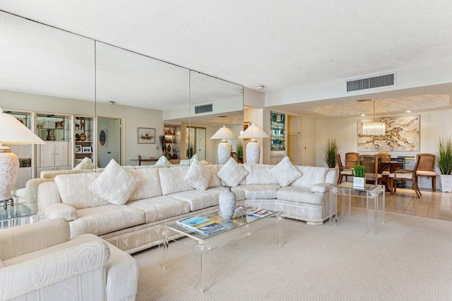 living room with light tile patterned floors and a textured ceiling