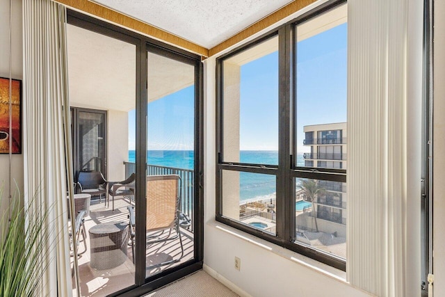 entryway with carpet and a water view