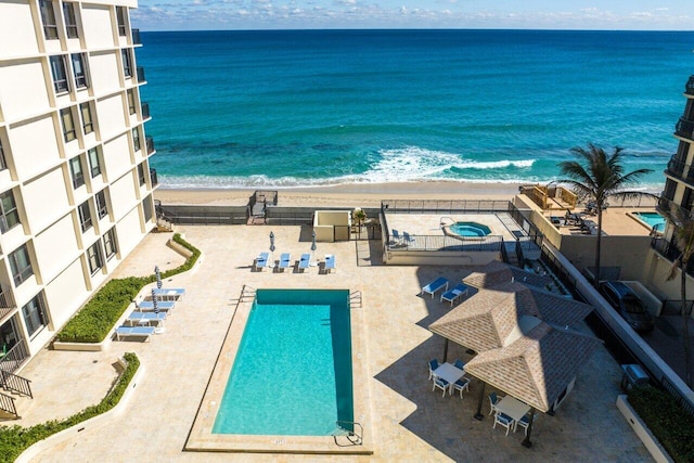 exterior space with a view of the beach, a patio, and a water view