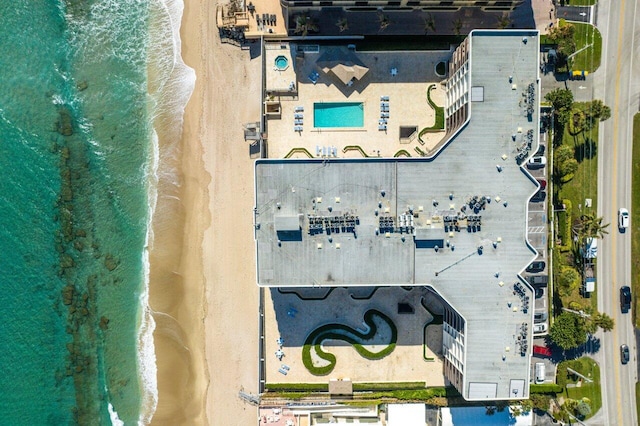 aerial view with a water view and a beach view