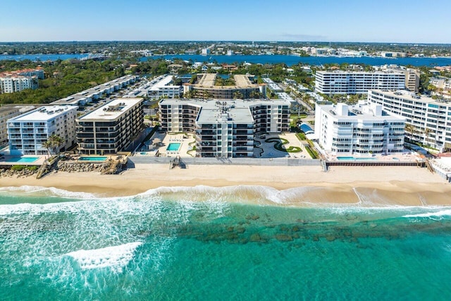 drone / aerial view featuring a view of the beach and a water view