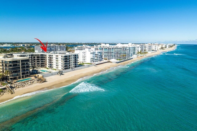 bird's eye view featuring a water view and a beach view