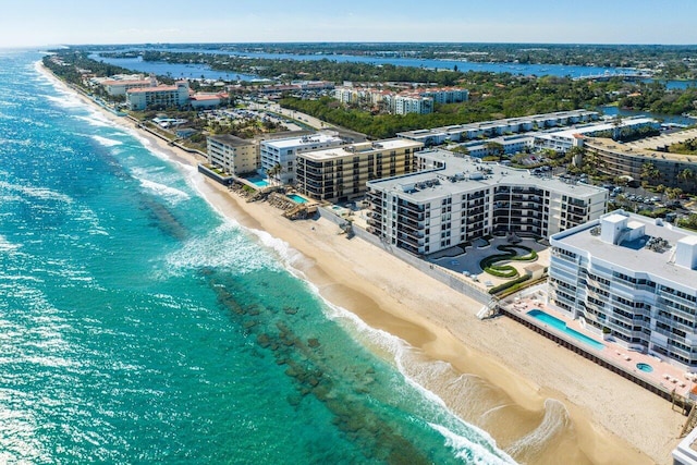 aerial view with a water view and a beach view