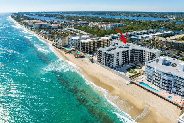 bird's eye view with a water view and a view of the beach